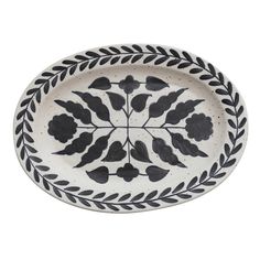 a black and white plate with leaves on it