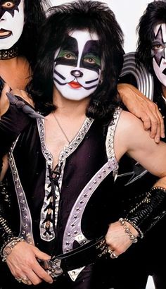 the kiss band is posing for a photo with their faces painted like cats and dogs