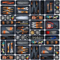 an assortment of tools are displayed in black trays with orange handles and forks on them