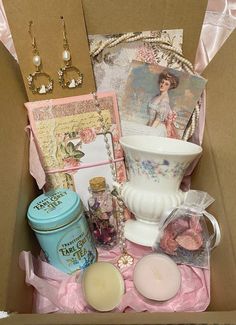 a box filled with lots of items like candles, cards, and other decorative items