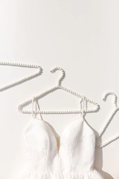 Display your jackets, wedding dress or even bridesmaid dresses on these trendy Pearl Hangers! These beauties will bring charm to your wedding day and are the perfect accessories for your wedding pictures. Bridal Party Checklist, Pearl Hangers, Bride Hangers, Hangers For Wedding, Pearl Hanger, Wedding Dress Hangers, Bride Hanger, Party Checklist, Wedding Dress Hanger