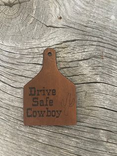 a brown leather tag that says drive safe cowboy