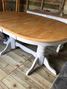 a wooden table sitting on top of a hard wood floor