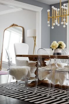 a dining room table with chairs and a chandelier