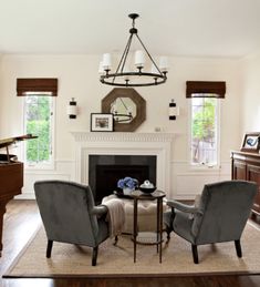 a living room with two chairs and a piano