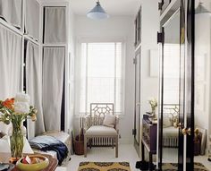 a white room with lots of windows and furniture