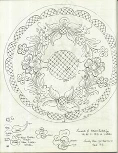 a drawing of a circular design with flowers and leaves in the center, on top of a