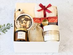 an open gift box with candles, cookies and other items