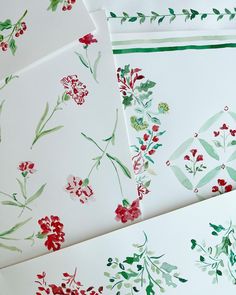 four cards with red and green flowers on them