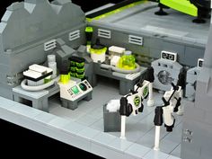 this is a lego model of a kitchen and dining area with green accents on the walls