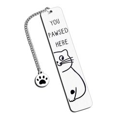 a bookmark with a dog's paw on it that says, you pawsed here