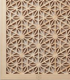 an intricate wooden panel with geometric designs on the outside and inside, made out of wood