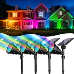 three solar powered lights in front of a house with the image of a rainbow light