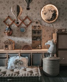 a living room filled with lots of furniture and wallpaper covered in clocks above it