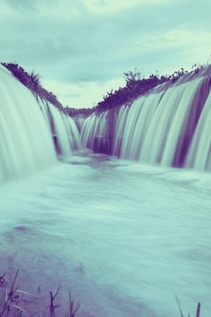 a large waterfall with water flowing over it