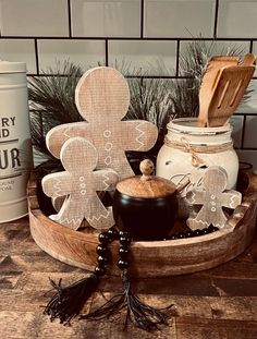 a wooden tray with cookies and jars on it