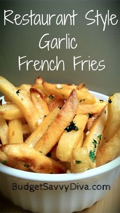 french fries in a white bowl on a wooden table with the words restaurant style garlic french fries