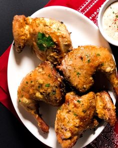 chicken wings on a plate with dipping sauce