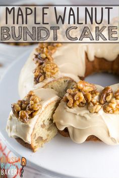 a white plate topped with a bundt cake covered in frosting and walnuts