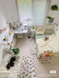 an aerial view of a small bedroom with white furniture and decorations on the walls, windows, and floor