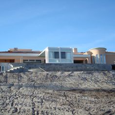 a house on top of a hill with stairs leading up to it