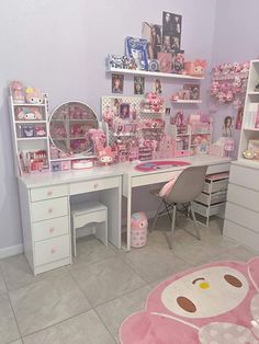 a room filled with lots of pink furniture and accessories on top of a white desk