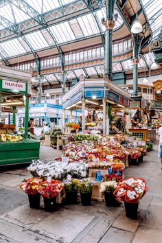 an indoor market with lots of fruits and vegetables on display in it's stalls