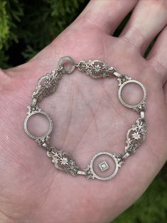 For sale is the beautiful Art Deco 14k White Gold Filigree Bracelet. It measures 7” and weighs 9.1 grams. It has 3 pieces of camphor glass and a small diamond. It’s in excellent condition. It’s been X-ray tested at 14k. Please contact me with questions. Gold Filigree Bracelet, Bracelet White Gold, Filigree Bracelet, Gold Filigree, Art Deco Era, X Ray, Bracelets And Charms, Vintage Watches, Antique Vintage