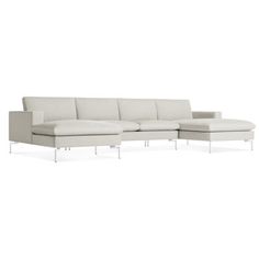 a white sectional couch sitting on top of a white floor