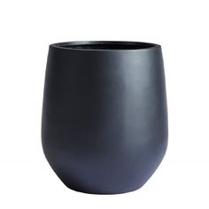 a black vase sitting on top of a white table