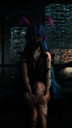 a woman with blue hair and tattoos sitting in the dark