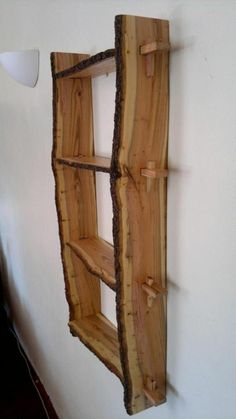 a shelf made out of wood is hanging on the wall