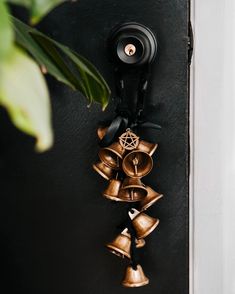 a bunch of bells hanging from the side of a door