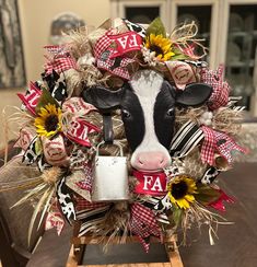 a cow head is adorned with sunflowers and burlocks