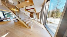 the stairs in this modern house are made of wood and glass, with no railings