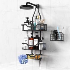 a bathroom with a shower head, soap dispenser and shelves