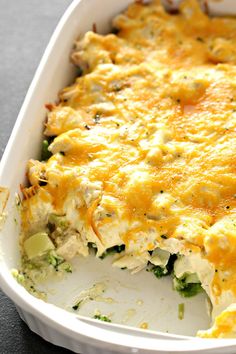 a casserole dish with broccoli, cheese and other items in it