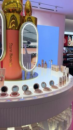 there is a display in the store with cosmetics and makeup products on it's counter