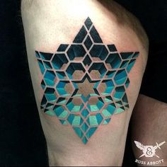 an abstract tattoo design on the left arm and shoulder, with geometric shapes in shades of blue