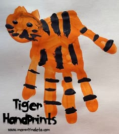 an orange tiger handprint with black stripes on it and the words tiger hands written below