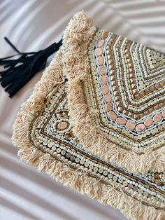 Cream toned beaded boho clutch bag with beading work and trim of tassels . Accompanied by braided leather sling Bohemian Clutch Bag With Tassels, Bohemian Beaded Clutch For Festivals, Bohemian Handheld Handmade Clutch, Bohemian Tassel Clutch Bag, Bohemian Clutch With Handwork, Bohemian Clutch, Clutch Bag Wedding, Crossbody Clutch, Boho Bags