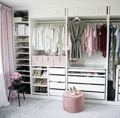 an organized closet with clothes and shoes