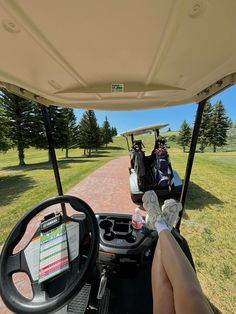 a person driving a golf cart on a dirt road