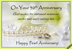 an anniversary card with two wedding rings and pearls