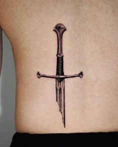 A sword tattoo is one of the most iconic designs. But only a few people know the true meaning behind it. Dive into our research to become a real sword tattoo lord. Alpha Male Tattoo, Blue Ribbon Tattoo, October Tattoos, Fine Tattoos, Seoul Hongdae, Hammer Tattoo, Lotr Tattoo, Lord Of The Rings Tattoo, Shamrock Tattoos