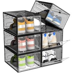 four clear storage containers filled with different types of shoes and other items on top of each other