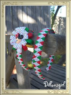 a close up of a wreath on a wooden fence with an ornament in the middle