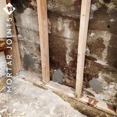 the corner of a room that has been stripped off and is being remodeled with wood framing