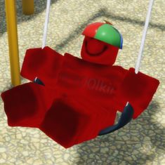 an animated image of a person on a swing in a playground with other children's toys