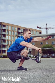 a man squatting on one leg while holding a frisbee